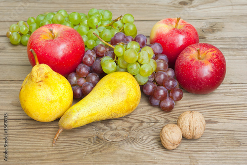 apples grapes and pears  wooden table