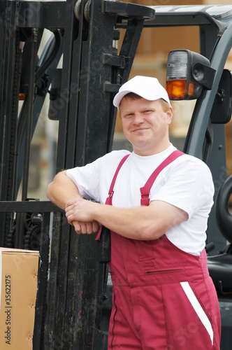 warehouse worker in front of forklift