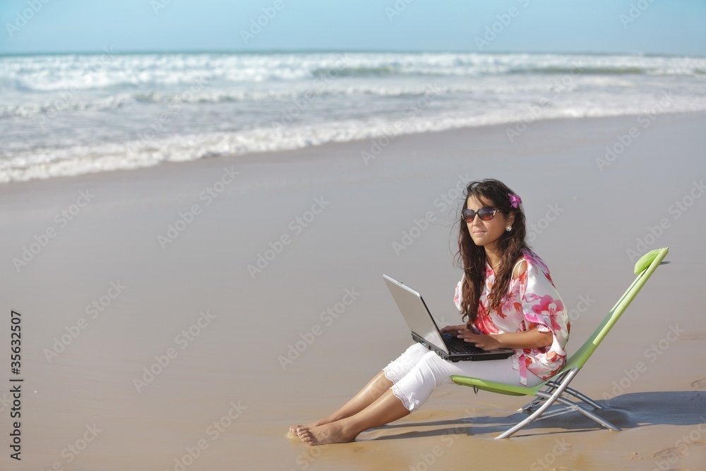 woman and laptop at sea