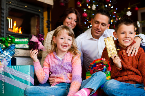 Weihnachten - Familie mit Geschenken am Weihnachtsabend