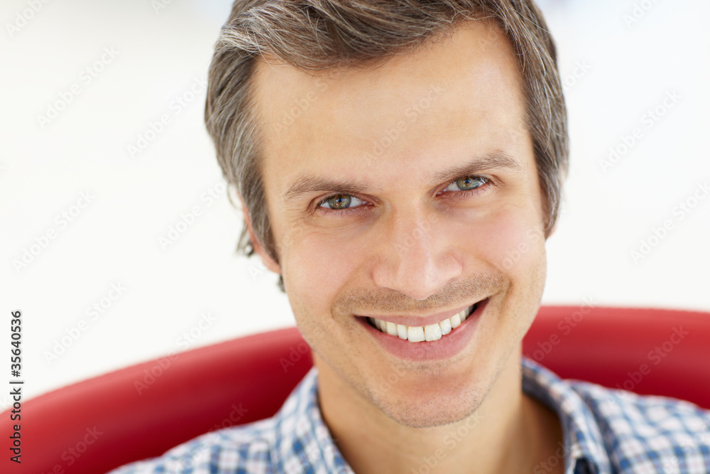 Fototapeta premium Man sitting in red chair