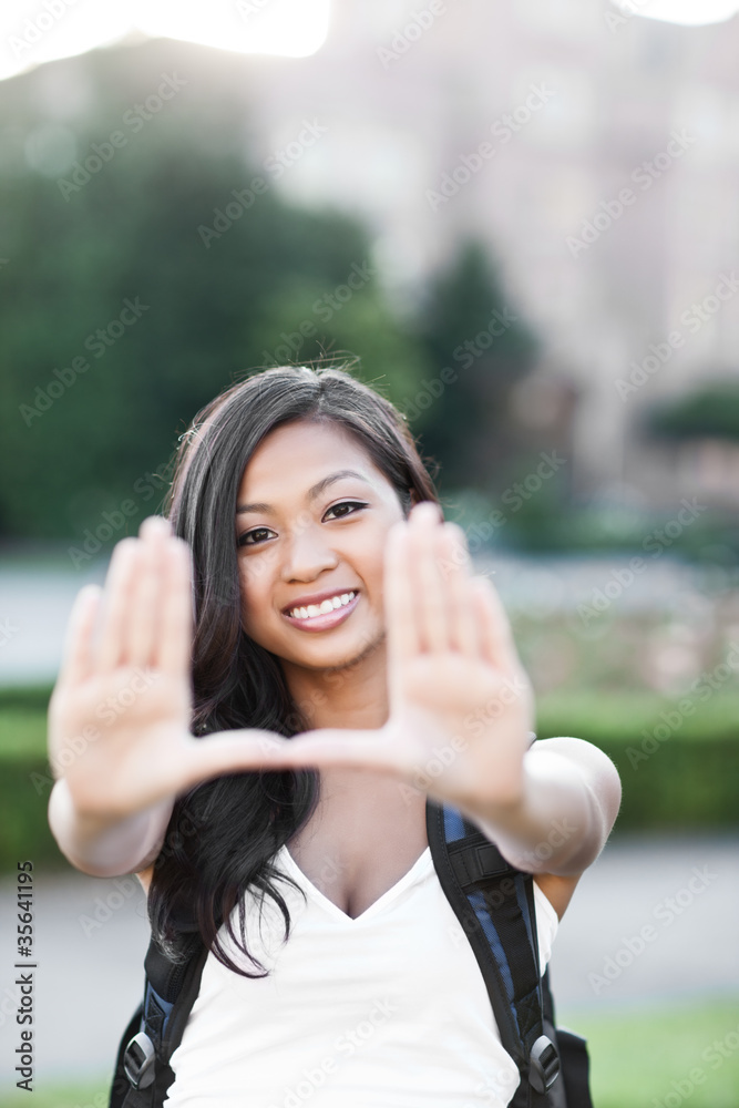 Asian college student making a frame Asian college student making a frame