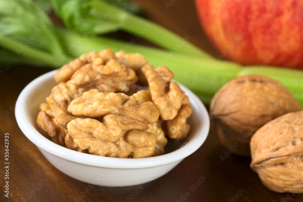 Raw walnut halves with celery and apple Raw walnut halves with celery and apple