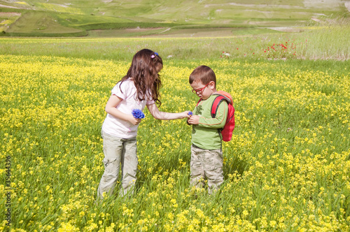 Children playing among field of flowers