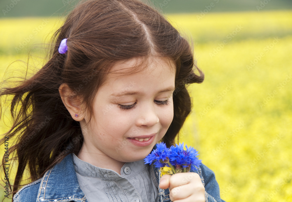 Girl playing among field of flowers Girl playing among field of flowers