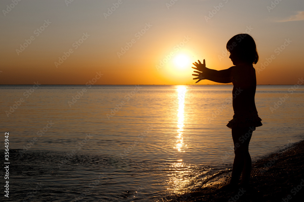 Child on sunset beach