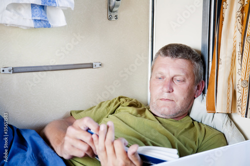 Mature man riding a sleeper train