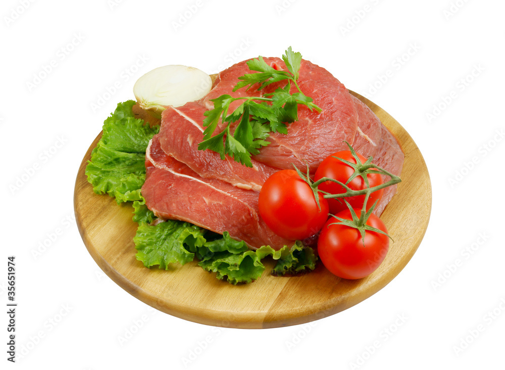 Raw beef meat with fresh vegetables on cutting board Raw beef meat with fresh vegetables on cutting board