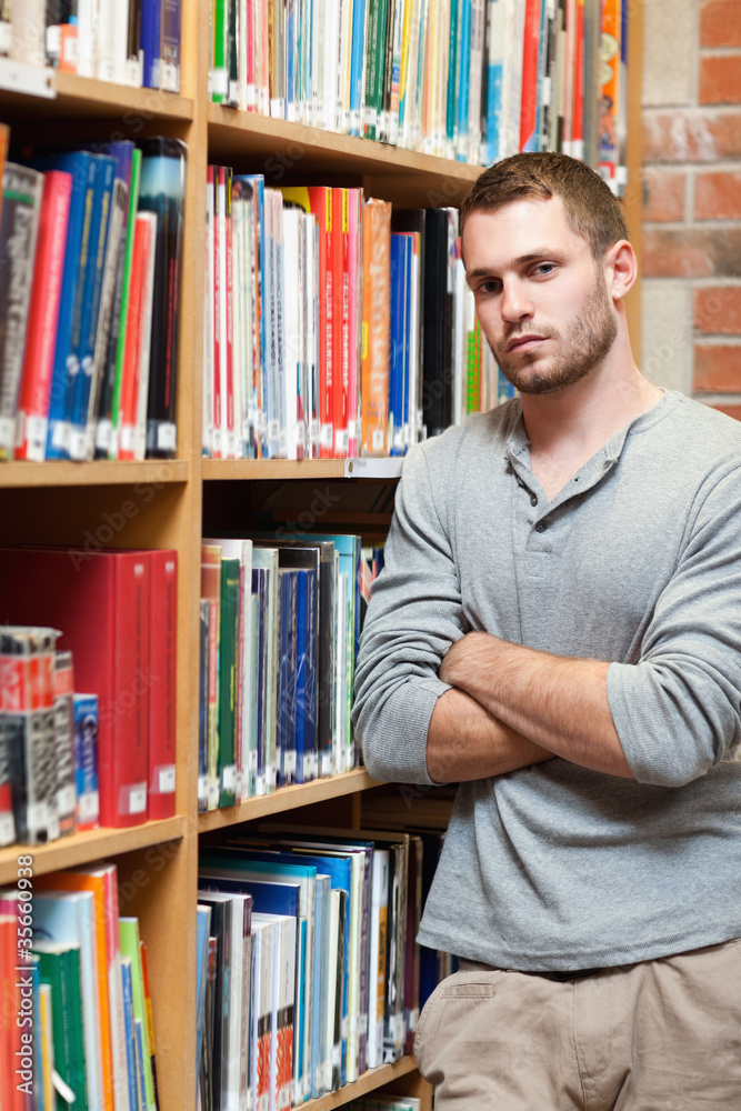 Portrait of a male student leaning on a shelf Portrait of a male student leaning on a shelf
