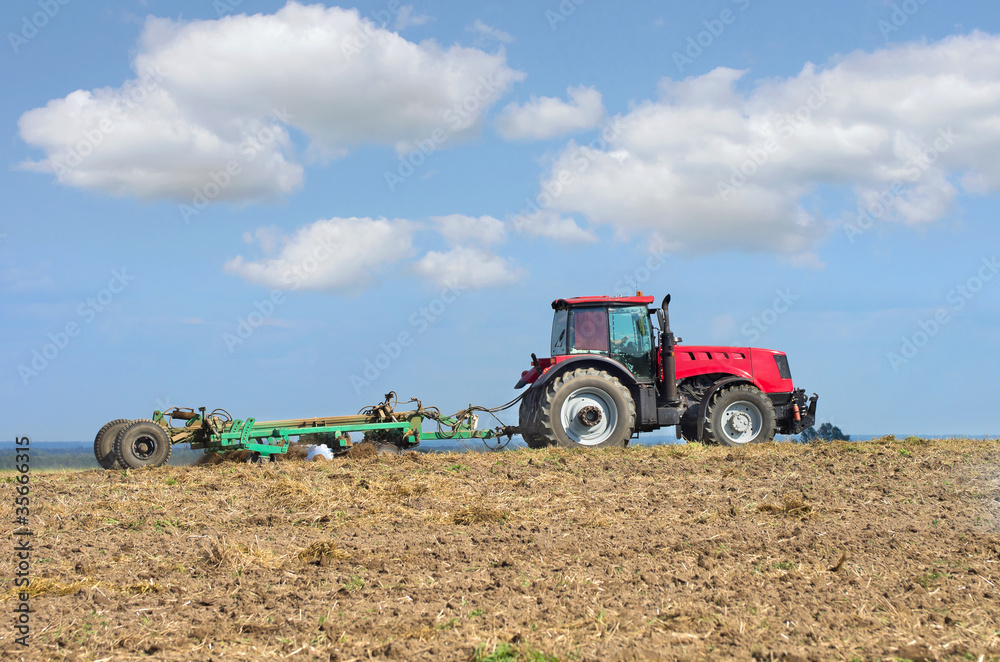 Tractor with cultivator handles field before planting Tractor with cultivator handles field before planting