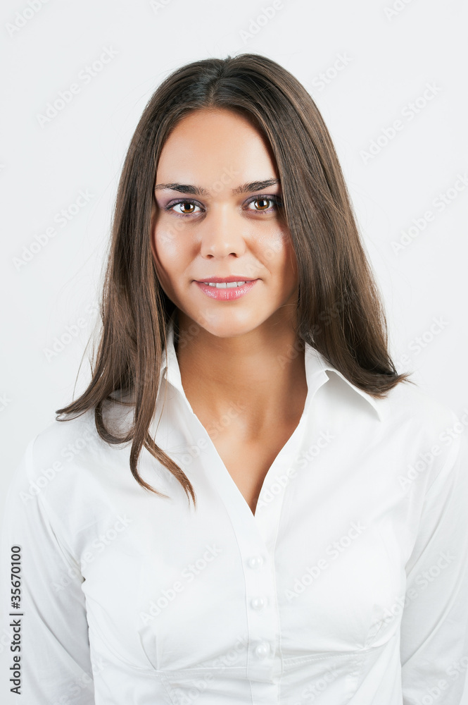 Closeup of happy young woman smiling on plain background Closeup of happy young woman smiling on plain background