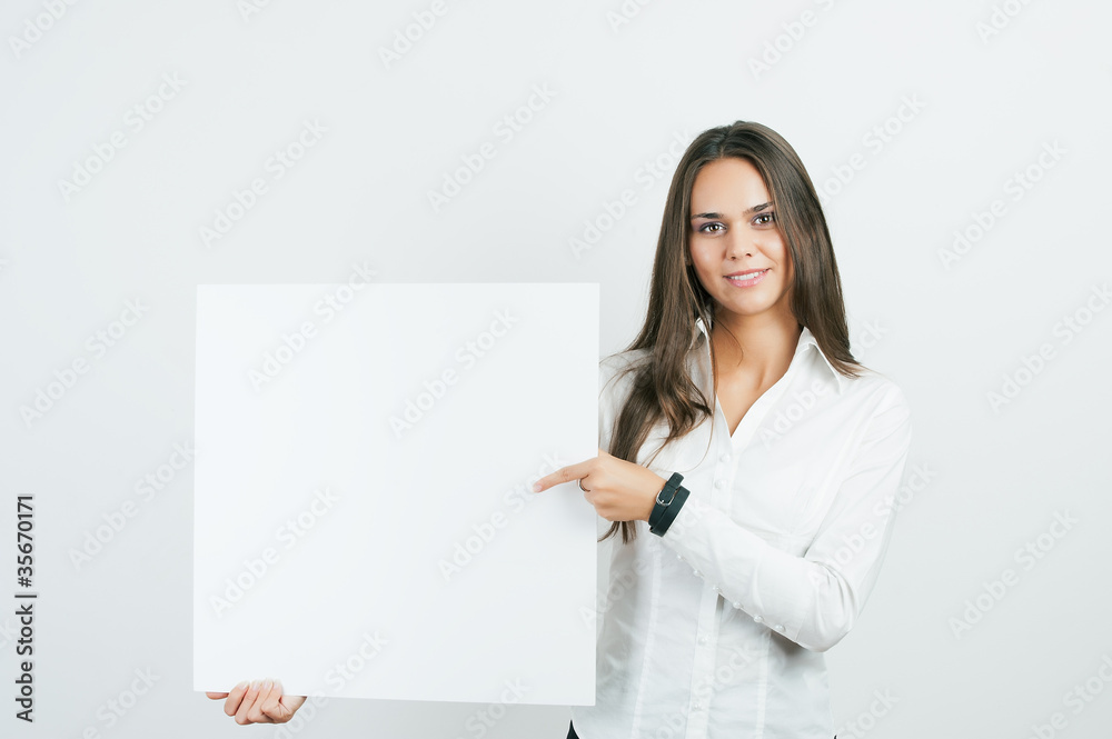 Happy smiling young business woman showing blank signboard Happy smiling young business woman showing blank signboard