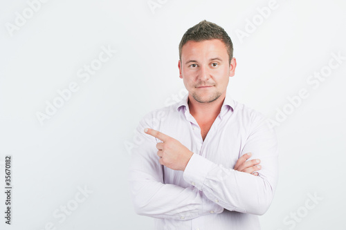 Man pointing showing copy space isolated on white background © lpstudio