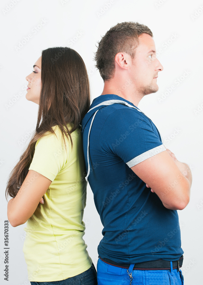 Young couple standing back to back having relationship difficult Young couple standing back to back having relationship difficult
