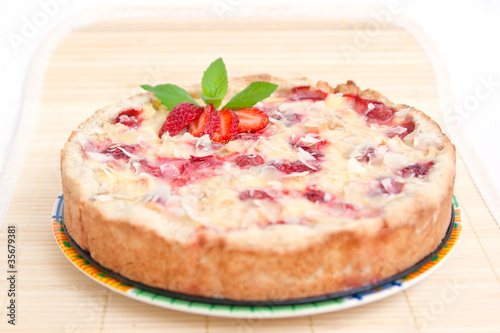 Strawberry pie decorated with ripe strawberry, mint and almond f