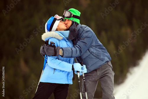 Portrait of kissing couple of skiers