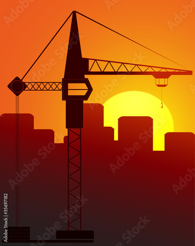 construction crane against the evening city