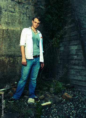 Cross Process photo of man by old wall