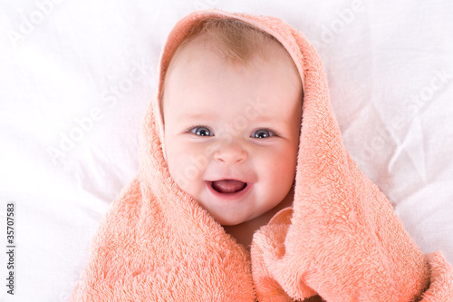 A cute baby wrapped in a towel..