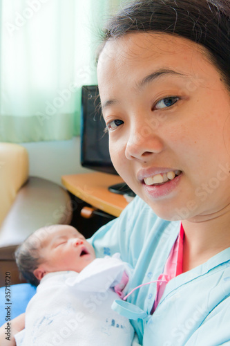 Asian female with newborn in arms