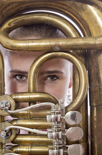 Close-up of girl staying behind a musical instrument