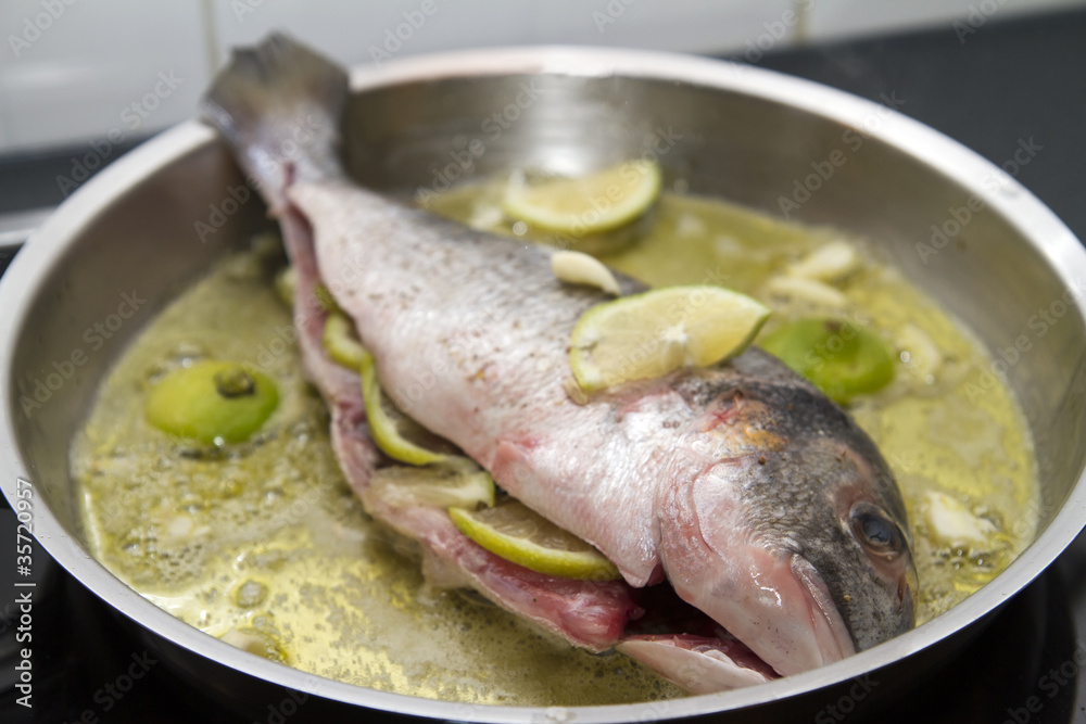 Dorade in a pan filled with lemons Dorade in a pan filled with lemons
