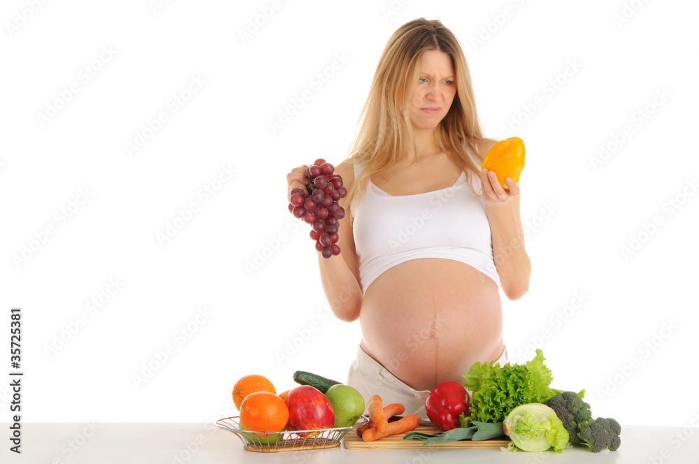 Unhappy pregnant woman with fruits and vegetables Unhappy pregnant woman with fruits and vegetables