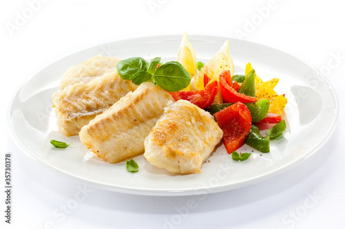 Canvas Print Fish dish - fried fish fillets and vegetables