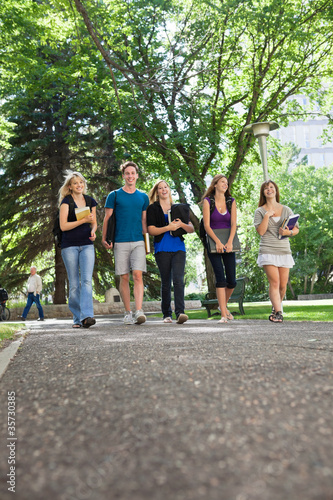 Fototapeta Naklejka Na Ścianę i Meble -  Happy Students Walking on Campus