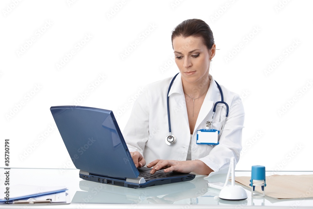 General practitioner typing on computer General practitioner typing on computer
