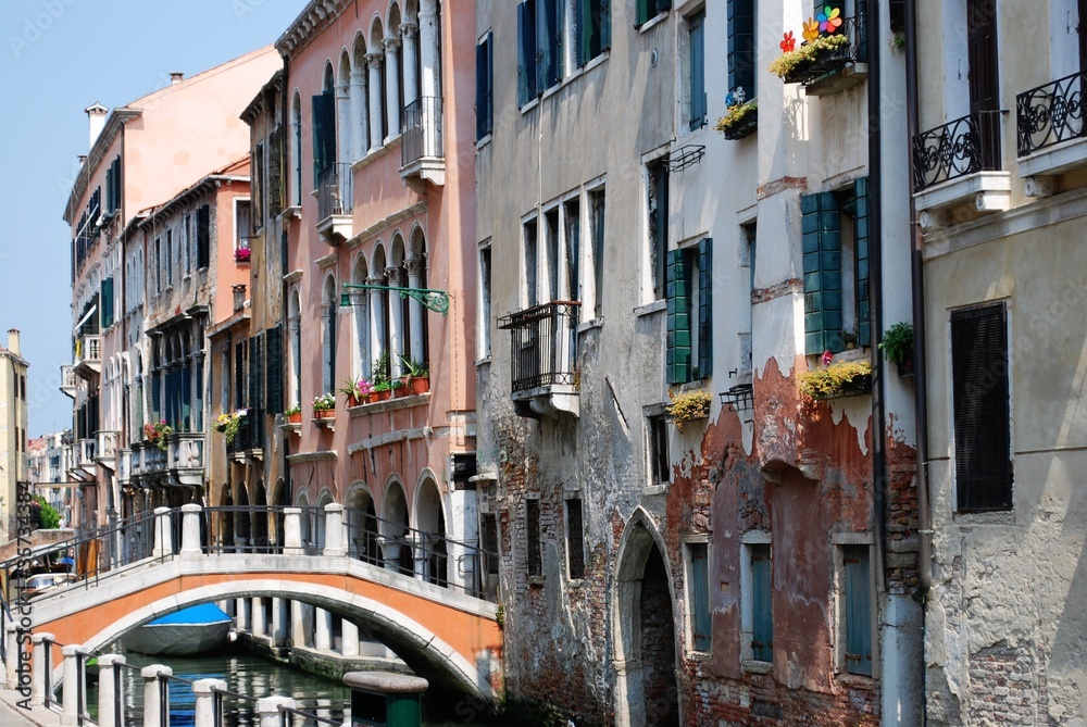 Canal with ancient houses and bridge in Venice, Italy