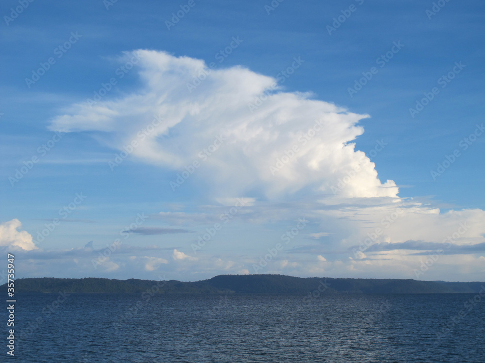 Big white cloud grows into the sky from the sea Big white cloud grows into the sky from the sea