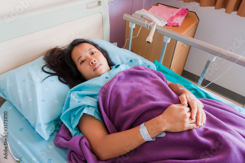 Asian female patient on bed