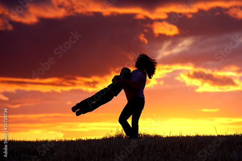 Swinging her son around.