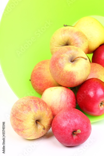 Fresh green, red apples in basket isolated