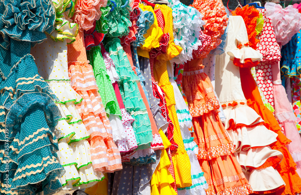 colorful gipsy dresses in rack hanged in Spain