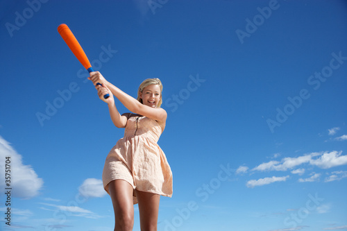 Teenage girl playing baseball