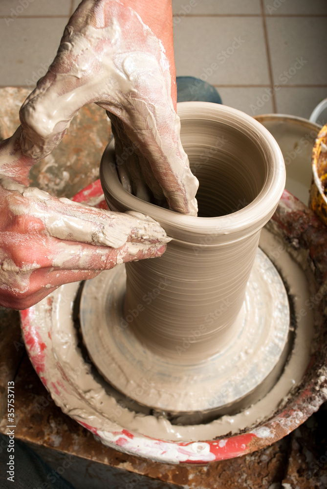 hands of a potter, creating an earthen jar on the circle hands of a potter, creating an earthen jar on the circle