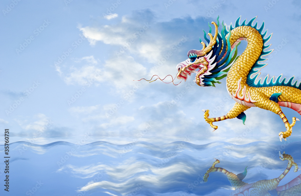 Golden dragon flying over the sea with nice sky background