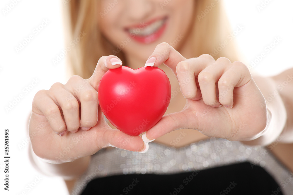 Beautiful young casual woman holding red heart Beautiful young casual woman holding red heart