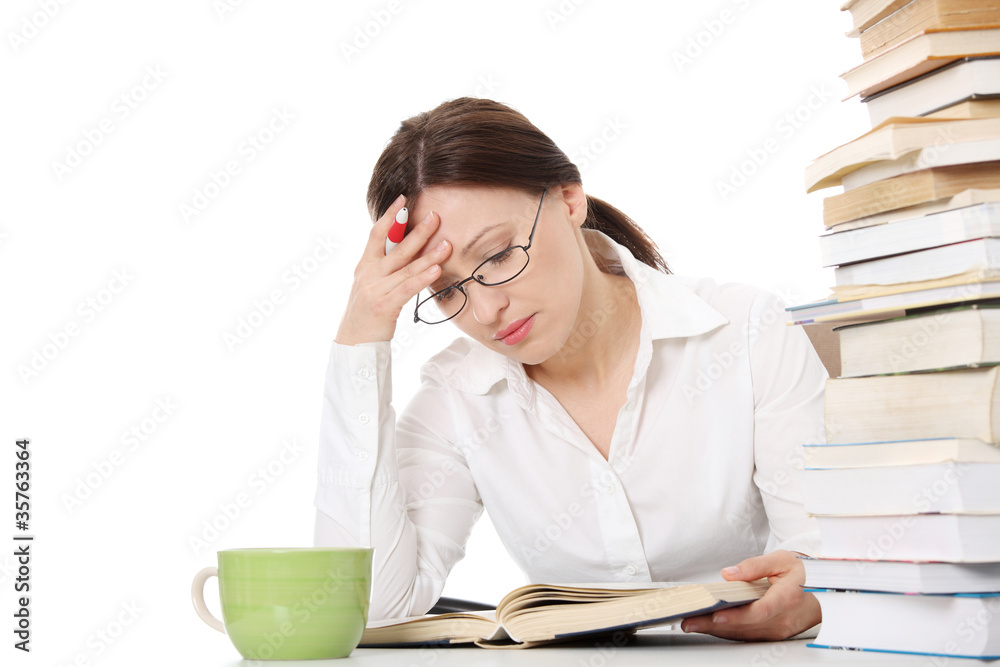 Mature student woman is learning at the desk Mature student woman is learning at the desk