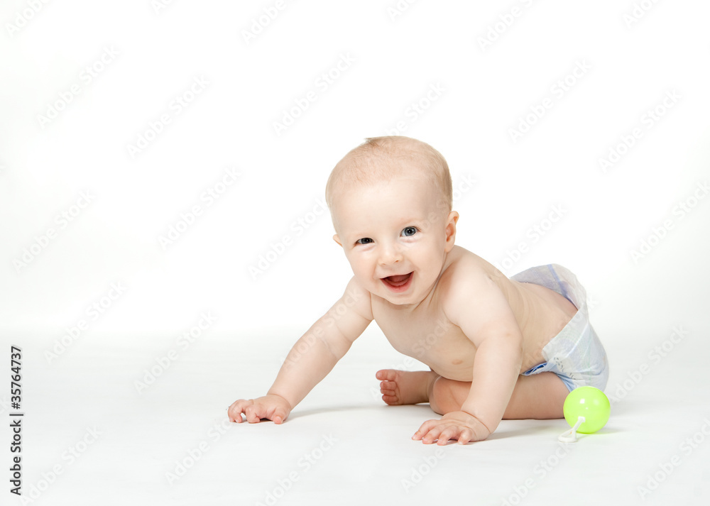 Six month boy sits on the white background and smiles Six month boy sits on the white background and smiles