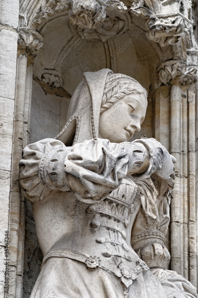 Beautiful statue of young woman in medieval dress