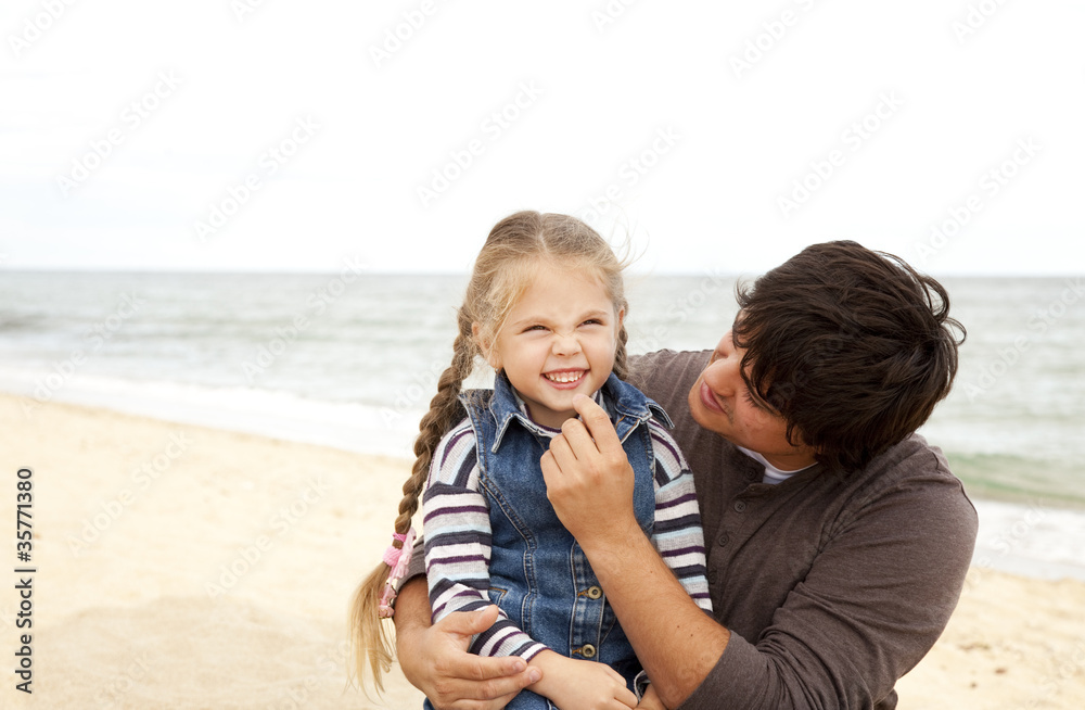 Father and daughter at the beach in fall. Father and daughter at the beach in fall.