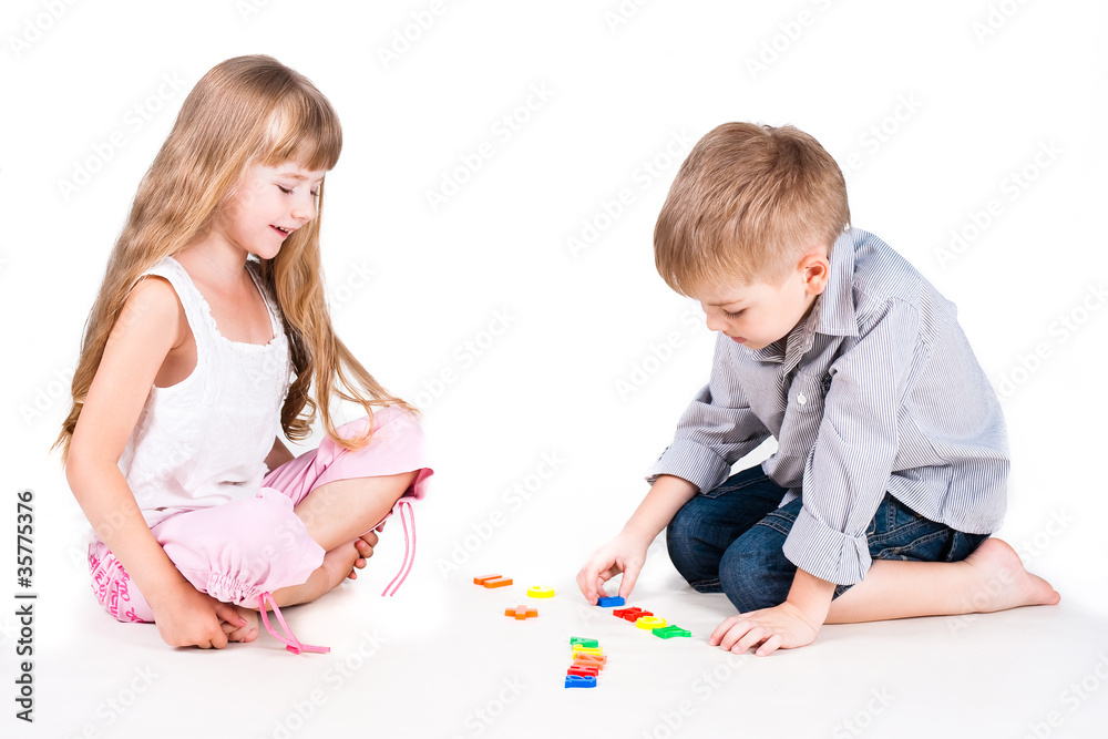 two playing kids with alphabet isolated on white background two playing kids with alphabet isolated on white background