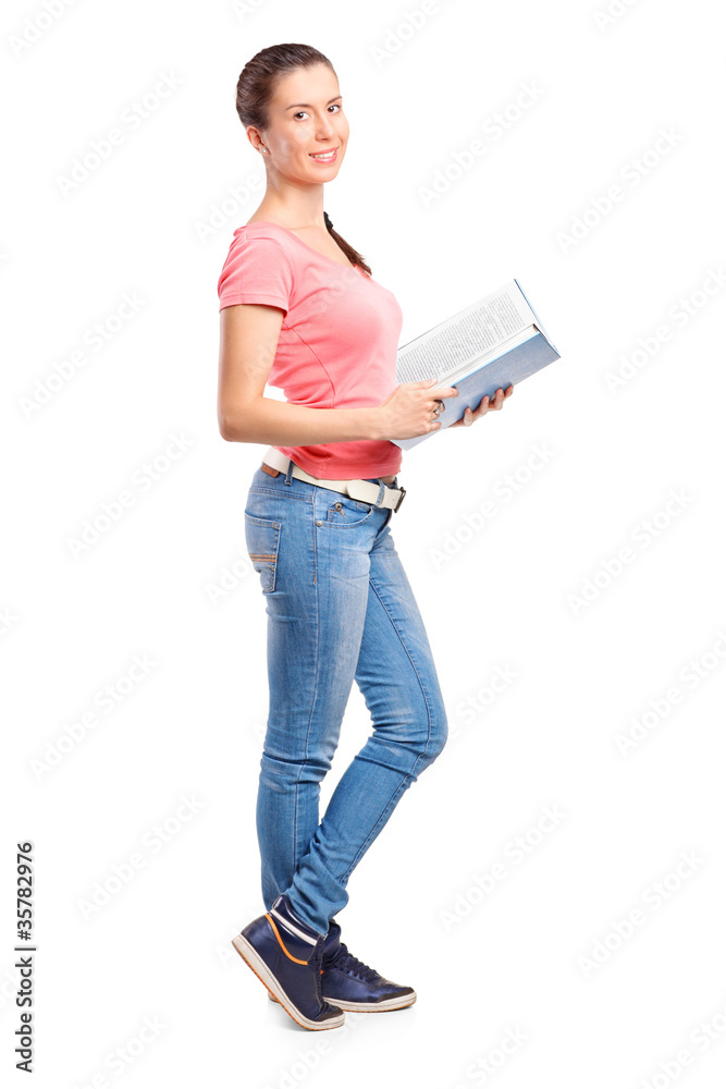Full length portrait of a school girl holding a book