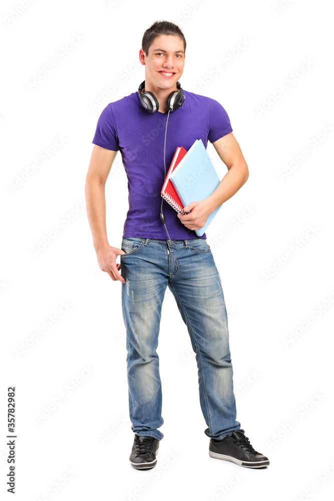 Smiling school boy with headphones holding books Smiling school boy with headphones holding books