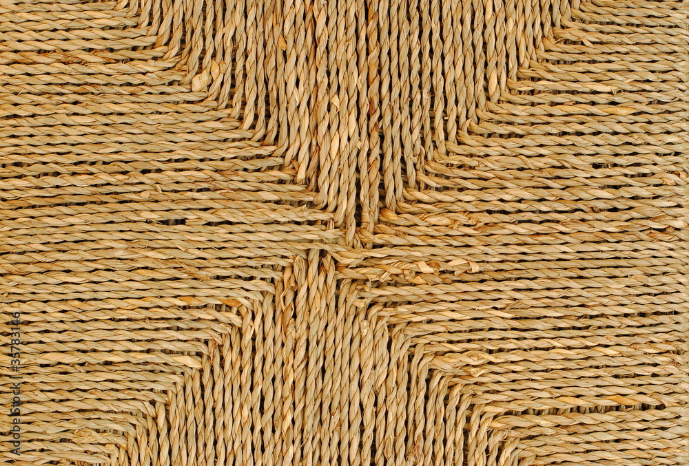 wicker basket with original pattern, straw background