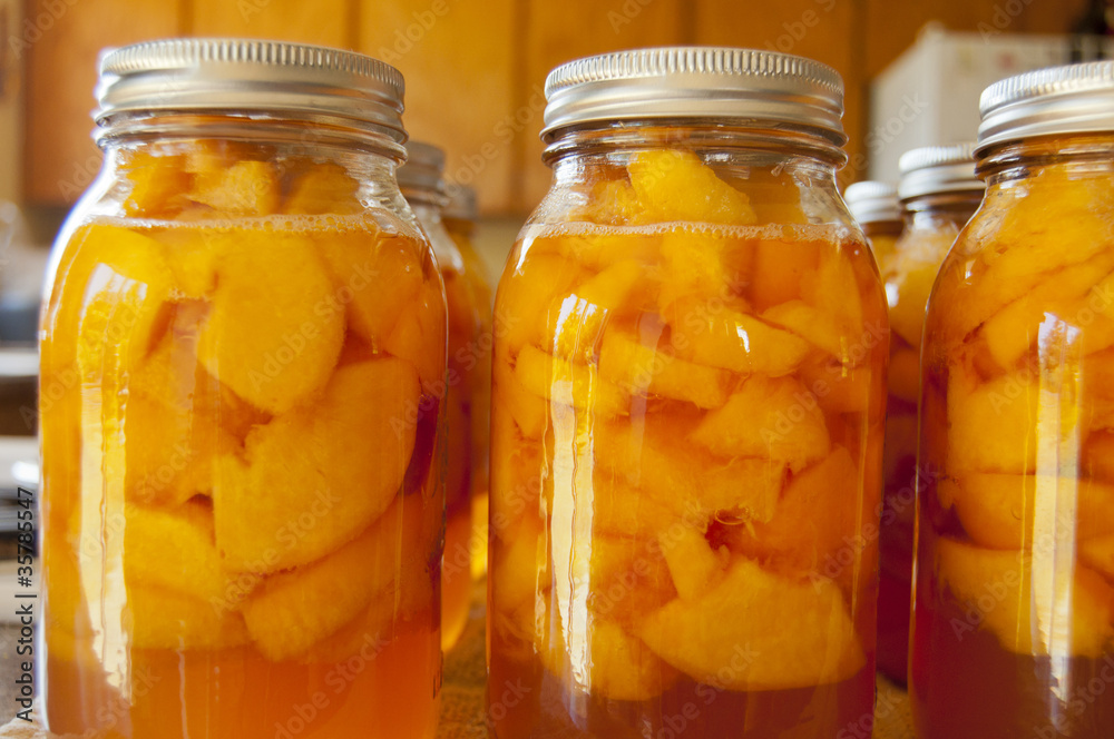 Glass jars of home canned peaches - obrazy, fototapety, plakaty 