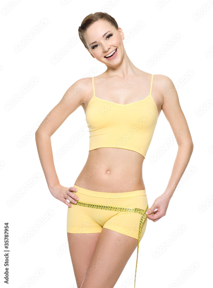 Laughing woman with sexy slim body measuring hips Laughing woman with sexy slim body measuring hips